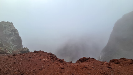 Foggy view on the edge of the active volcano crater of Mount Vesuvius, Province of Naples, Campania...