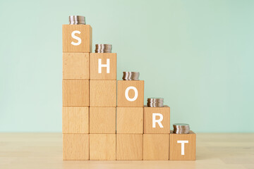 「SHORT」と書かれたブロックとコイン

