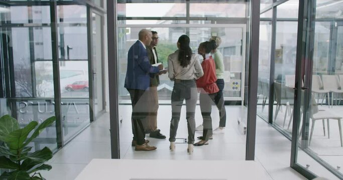 Laptop displaying green screen copyspace with a group of diverse business people planning and brainstorming on a glass wall in the office with in the background. Advertise and market your company
