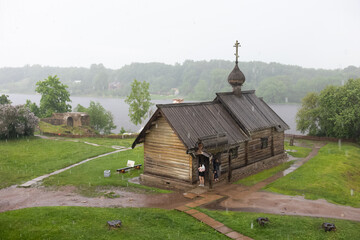 Wooden Orthodox Church in the rain, soft focus 