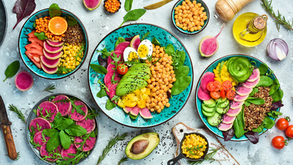Set buddha bowl. Clean and balanced healthy food concept. Quinoa, chickpeas, avocado, fresh vegetables and nutritious food, Halthy eating, dieting food concept on a stone background.