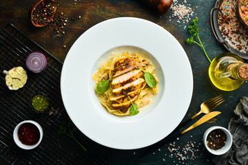 Pasta with chicken fillet, cheese and spinach. Italian cuisine. Menu. Top view.