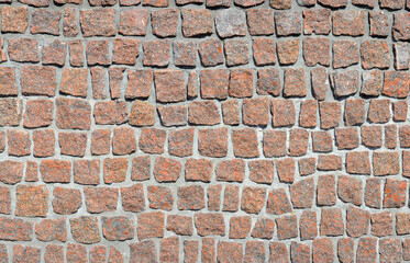 Retaining wall made of red granite. High resolution texture. noisy texture. Focus around the frame