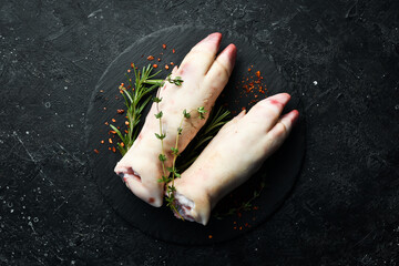 Raw pork leg. Meat. On a black background.