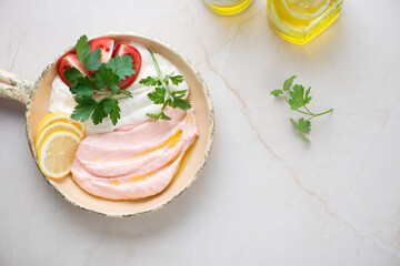 Serving pan with greek meze made of fish roe or taramosalata, flat lay on a beige stone background, horizontal shot with copyspace