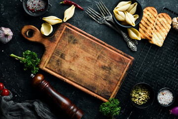 Old kitchen wooden brown board. On a stone background. Top view.
