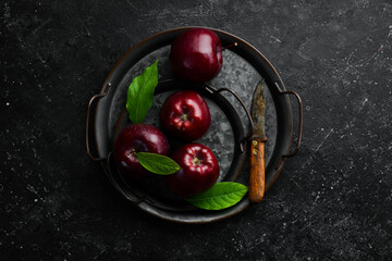 Fruits. Fresh juicy red apples. Rustic style. On a black stone background.