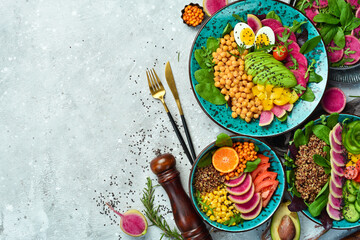 Buddha bowl: chickpeas, avocado, egg, watermelon radish and spinach. Delicious balanced nutrition...