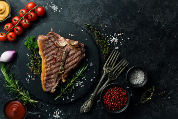 porterhouse steak or T Bone Steak dry aged of beef Ready to Cook on wooden Board with herbs, pepper...