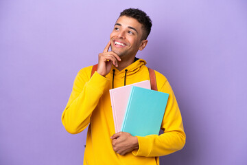 Young student Brazilian man isolated on purple background thinking an idea while looking up