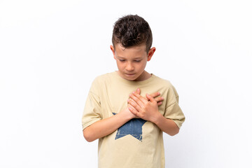 Little caucasian boy isolated on white background having a pain in the heart