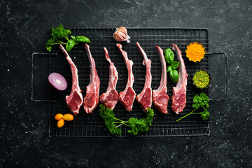 Raw lamb ribs and seasonings on the grill, to prepare for barbecue. Meat. Top view.