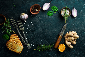 Cooking background. Vegetables, spices and kitchen utensils on a stone background. Top view.