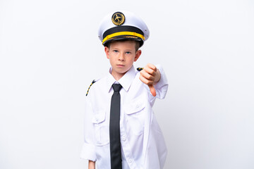 Little airplane pilot boy isolated on white background showing thumb down with negative expression