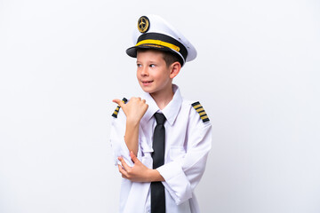 Little airplane pilot boy isolated on white background pointing to the side to present a product