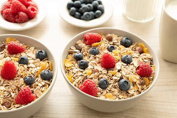 Zwei Schalen Müsli mit frischen Blaubeeren und Himbeeren