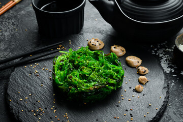 Chuka seaweed salad. Foods high in iodine. On a black stone plate.