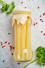 Homemade marinated white asparagus in a glass jar. Vegetarian healthy food. Food supplies. Top view.