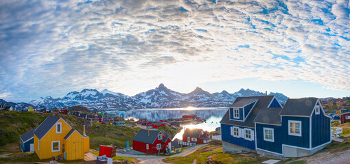 Night time in the northern hemisphere concept - Picturesque village on coast of Greenland - Colorful houses in Tasiilaq, East Greenland - obrazy, fototapety, plakaty