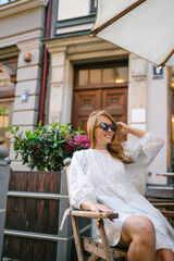 Young Woman chilling in cozy cafe, looking around , happy emotions. Traveling woman.