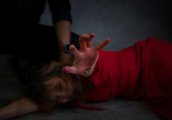 concept of violence against women,crime. bloody hand of female victims in red dress asking for help from being violence - obrazy, fototapety, plakaty