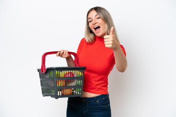 Young Rumanian woman holding a shopping basket full of food isolated on white background with...