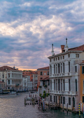 Incredible sunset, clouds and traditional venetian architecture seen from the grand canal in Venice, Italy