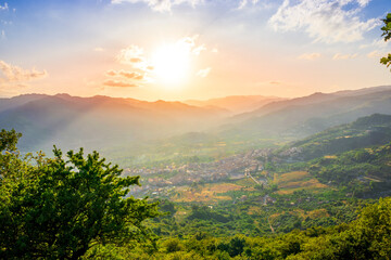 picturesque highland landscape with amazing view from mountain with green branches and leaves on sides