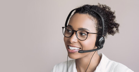 Young woman wearing headset. Portrait of customer service assistant talking on phone. Video...