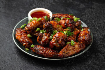 Baked chicken wings with spring onion and sweet chili sauce.