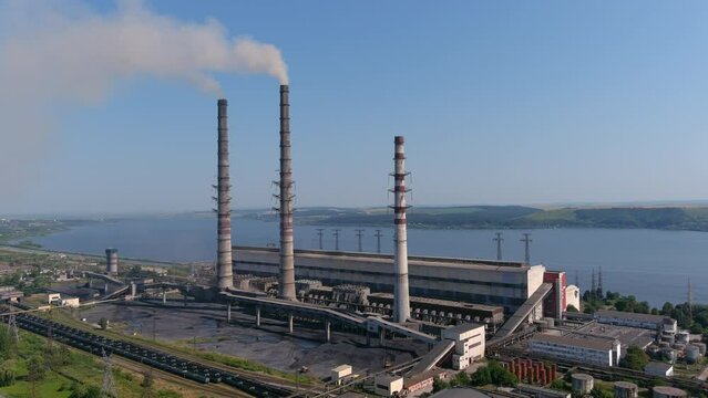 Thermal power plant. Large chp with high pipe 3 cooling towers. Smoke coming from pipes of a working chp. Environmental pollution. Smoke with harmful substances is ejected into air of atmosphere
