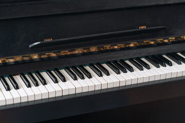 The old black piano. close-up of keys.