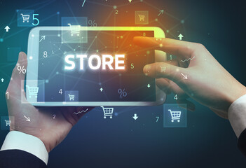 Close-up of a hand holding tablet with shopping inscription