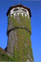 an old water tower overgrown with ivy