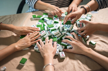 Women playing mahjong traditional Chinese board game at home - 516139624