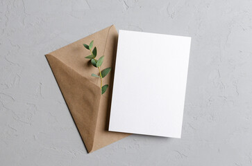 Invitation or save the date card mockup with envelope and fresh eucalyptus twig © nikavera