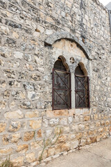 Stone facade of an ancient building in the Arab Christian village Miilya, in the Galilee, in northern Israel