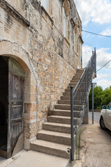 A stone staircase leading to the second floor is located on the stone facade of an ancient building in the Arab Christian village Miilya, in the Galilee, in northern Israel