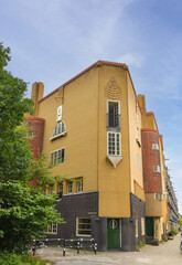 Amsterdam, Netherlands. June 2022. Details and facades of characteristic brick construction of residential building in Amsterdam School style architecture in Spaarndammerbuurt neighborhood