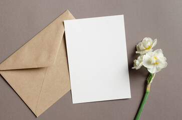 Blank greeting card mockup with envelope and daffodils flowers