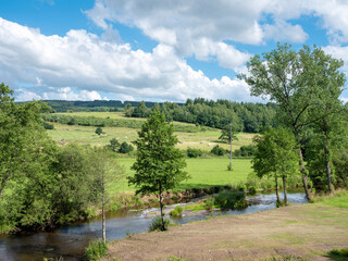 river ourthe occidentale in belgian ardennes region in summer under blue sky