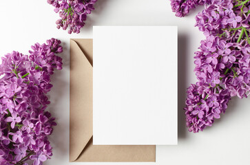 Blank wedding invitation card mockup with envelope and spring lilac flowers