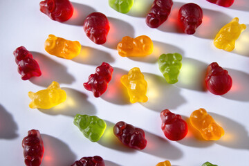 Marmalade animals of different colors with fruit juice lie on a white background