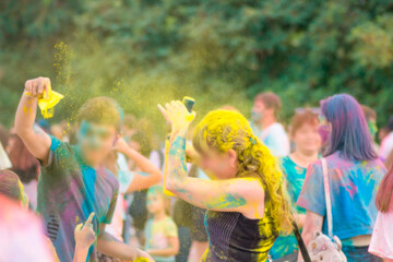 holi holiday! yellow paint on people's heads! multicolored paints are everywhere