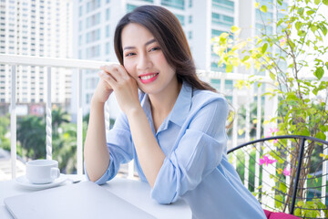 Image of young Asian business woman working at home