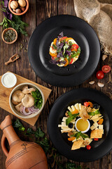 Appetizers for wine on wooden background. Georgian food menu. Cheese platter, tomatoes with mozzarella cheese and milk mushrooms in rustic style. Traditional appetizers - cheese mix, caprese, gruzdi.