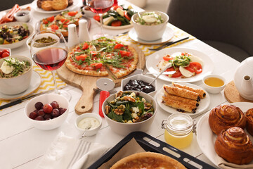 Many different dishes served on buffet table for brunch