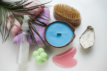 Fototapeta na wymiar spa theme. pastel colored towels, aroma candles, massagers and spa accessories