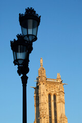Fototapeta na wymiar Street lamp and Saint Jacques tower