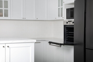 Modern oven and microwave in white clean kitchen